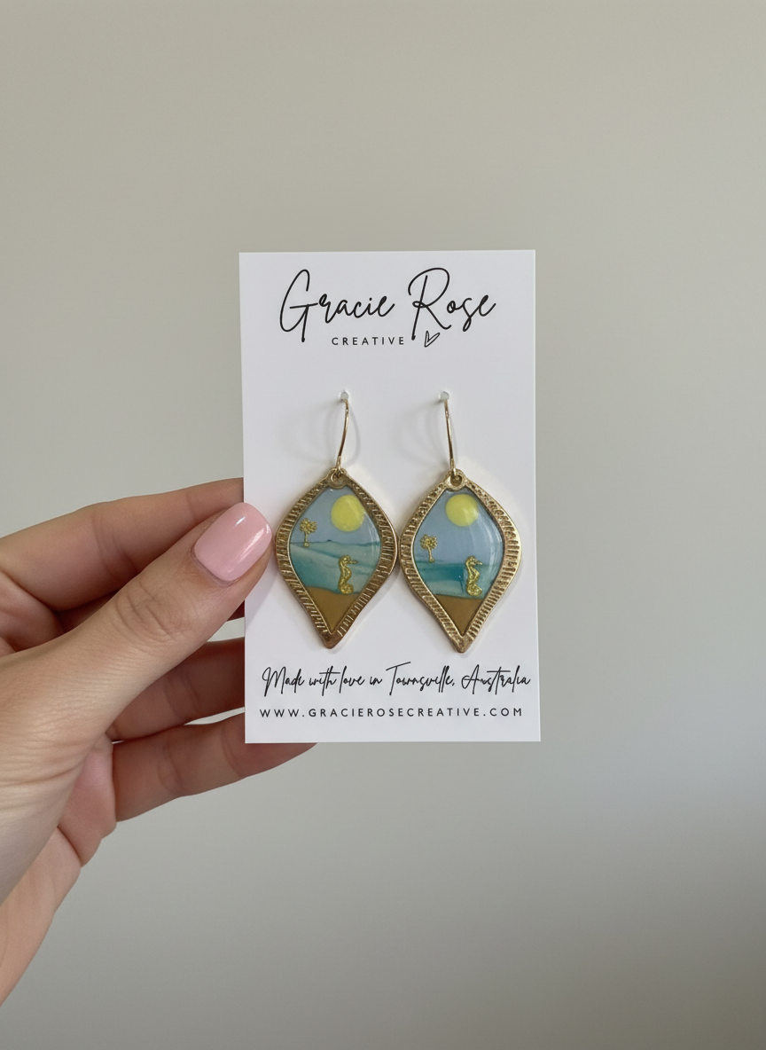 Close-up view of Costal Daydream earrings, highlighting the intricate design with blue and sandy elements, perfect for a coastal look.
