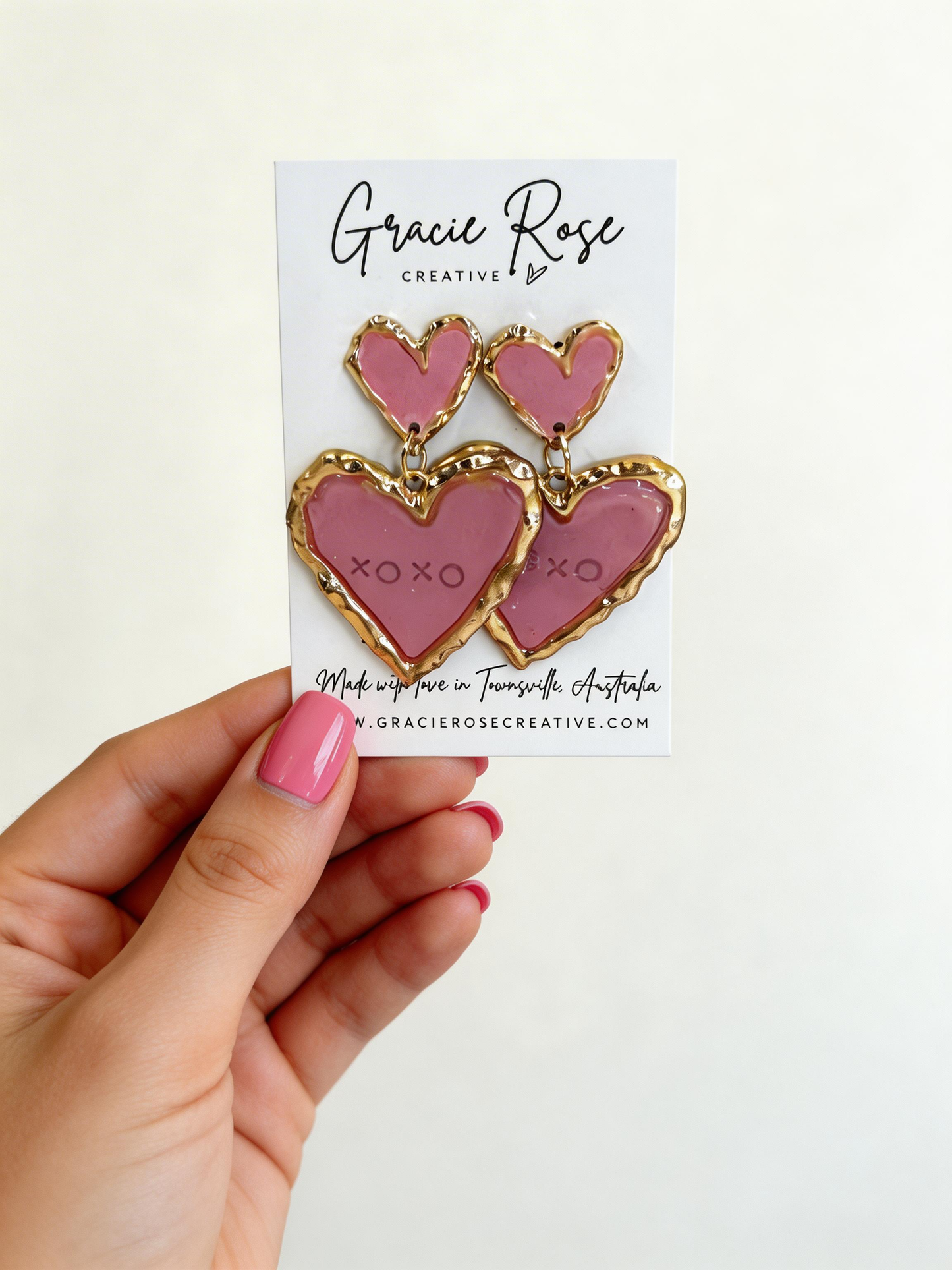 Close-up of the Double Sweetheart in Pink earrings showcasing their bold and lightweight design, ideal for adding a playful touch to any outfit.