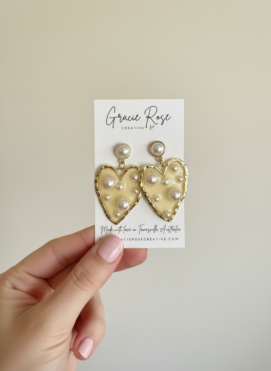 Opulent Hearts by Gracie Rose Creative, heart earrings displayed on a card, highlighting their unique gold and pearl design.