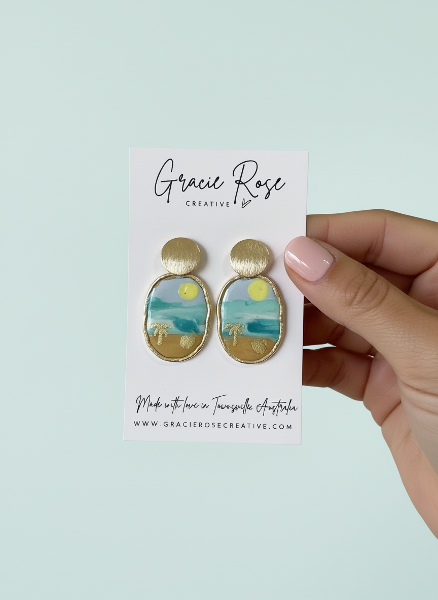 'Hello Sunshine' earrings by Gracie Rose Creative displayed on a card, featuring a vibrant tropical scene in polymer clay with gold accents.