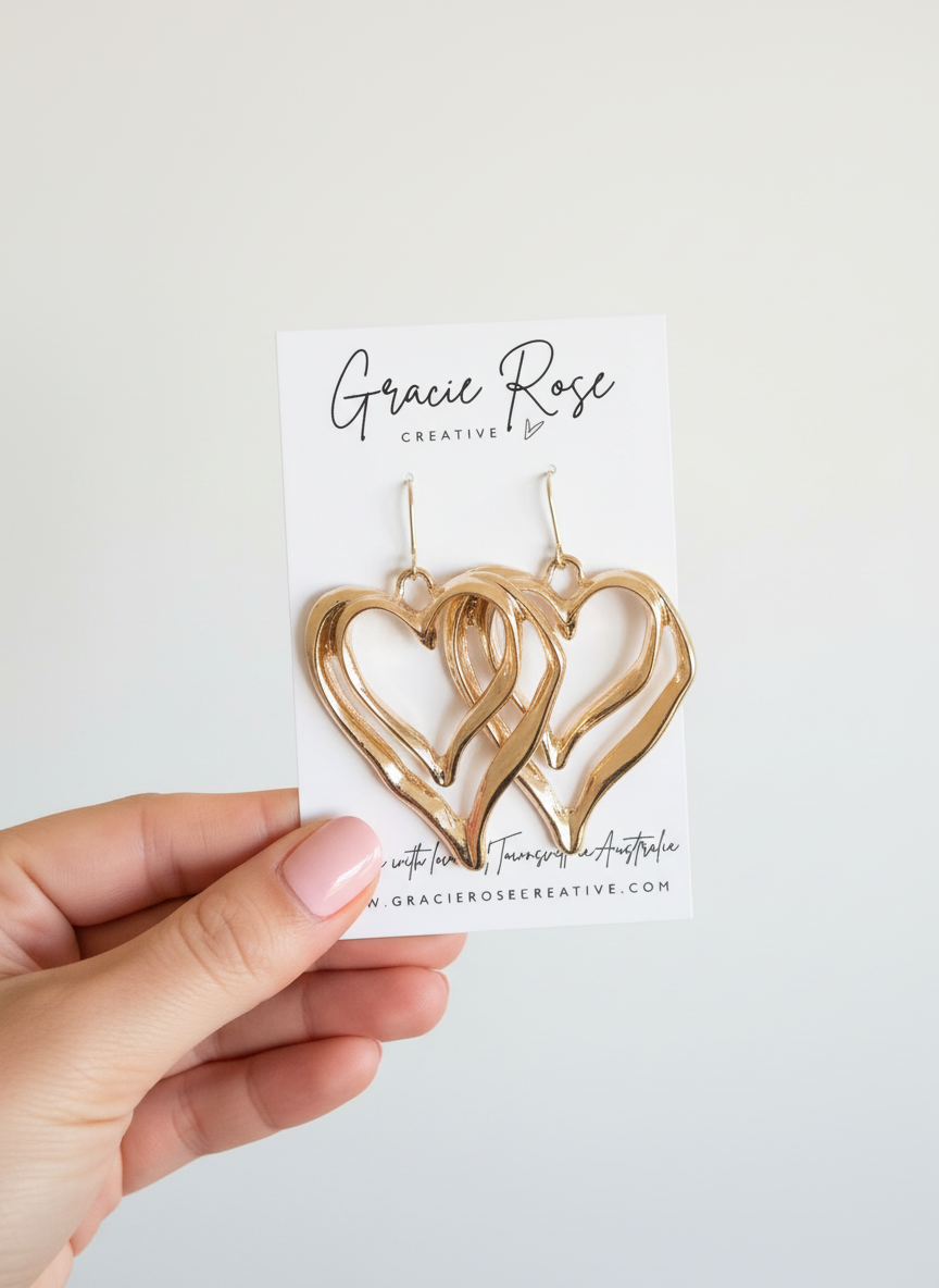 Stylish display of Double Heart Glow Drops earrings on a decorative background, emphasizing their bold and feminine statement design.