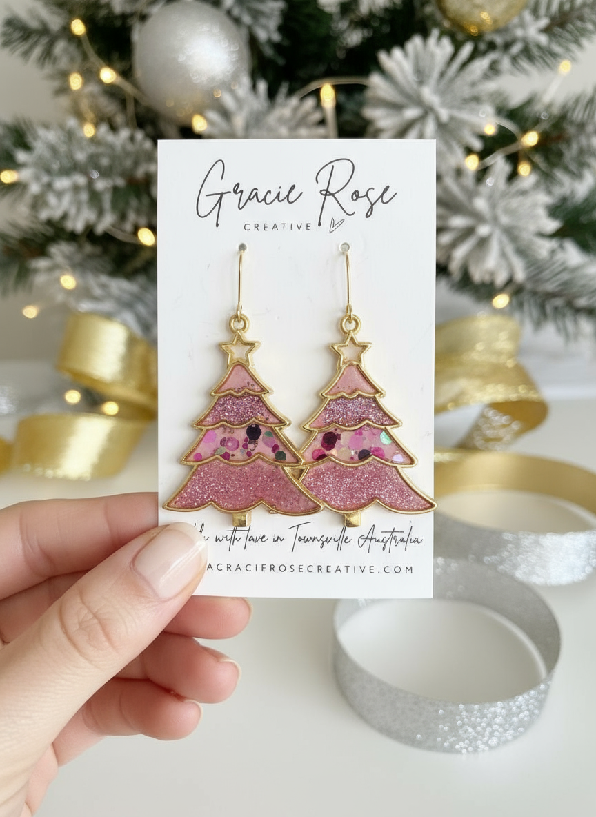 Oh Christmas Tree… (pink) earrings displayed on a card, made by Gracie Rose Creative, featuring a whimsical pink glittery Christmas tree design.
