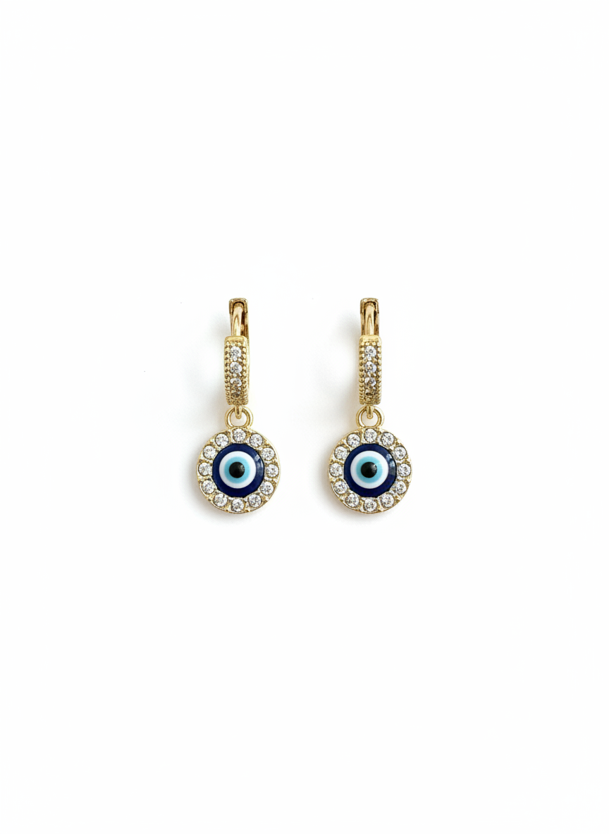 Evil Eye Crystal Huggie Earrings showcasing a gold-tone finish and shimmering crystal-encrusted charm, perfect for everyday wear.