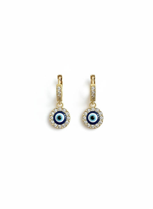Evil Eye Crystal Huggie Earrings showcasing a gold-tone finish and shimmering crystal-encrusted charm, perfect for everyday wear.