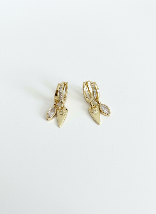 Eye of Love Huggies featuring a delicate golden heart and subtle evil eye motif, perfect for adding a stylish touch to any outfit.