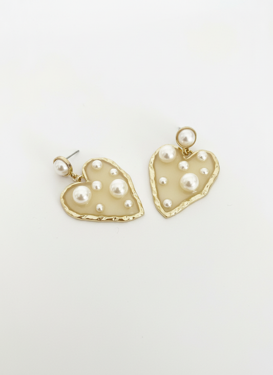 Opulent Hearts by Gracie Rose Creative, elegant gold-toned heart earrings adorned with lustrous pearls on a white background.