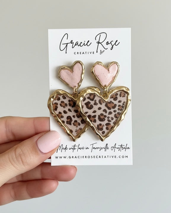 Cross Your Heart statement earrings perfectly displaying their lightweight feel and unique design, ideal for any outfit.