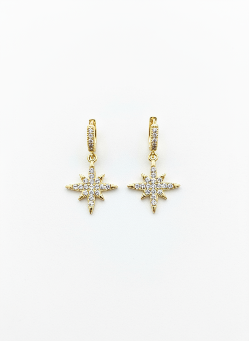 North Star Huggies by Gracie Rose Creative featuring a dazzling starburst design with gold plating and sparkling diamantés, perfect for adding cosmic elegance to your style.
