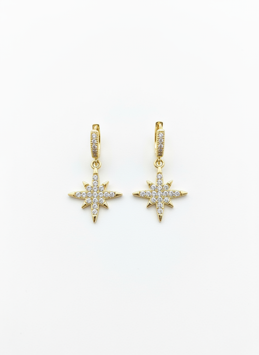 North Star Huggies by Gracie Rose Creative featuring a dazzling starburst design with gold plating and sparkling diamantés, perfect for adding cosmic elegance to your style.