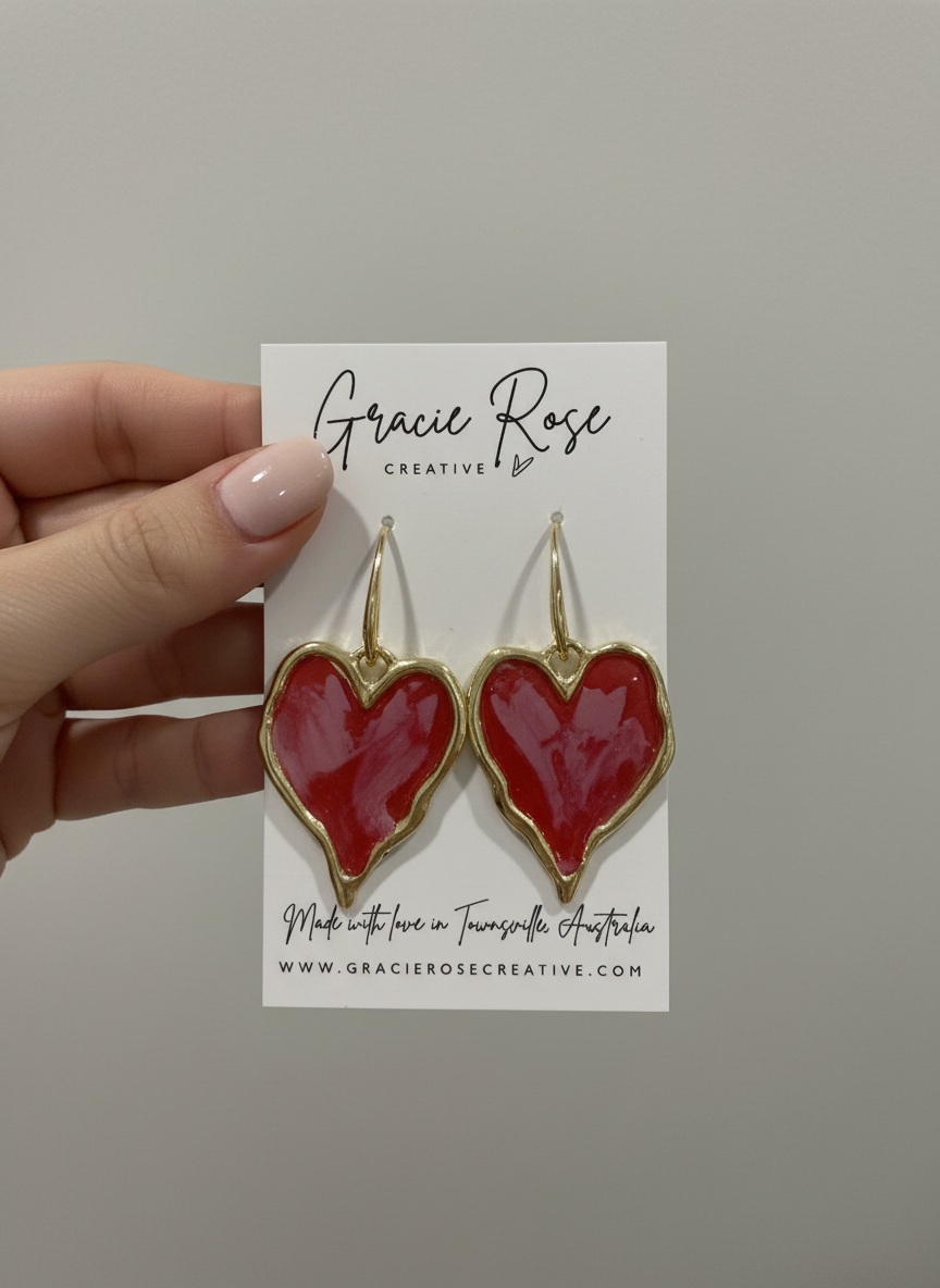 Stylish presentation of Red Hot Hearts earrings, highlighting their handmade quality and elegant drop length.