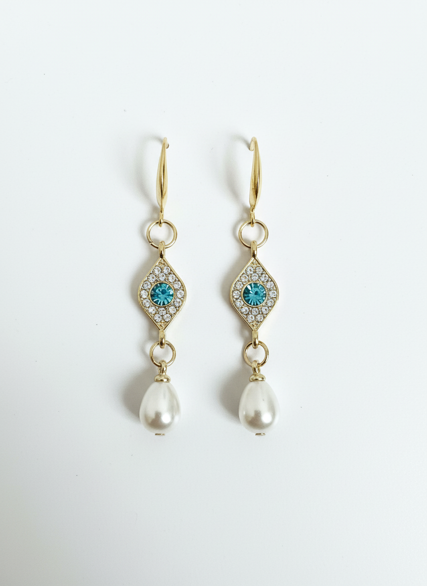 Evil Eye Pearl Drops - Gold-plated drop earrings with a sparkling crystal eye and soft pearl finish, perfect for adding glamour to any outfit.