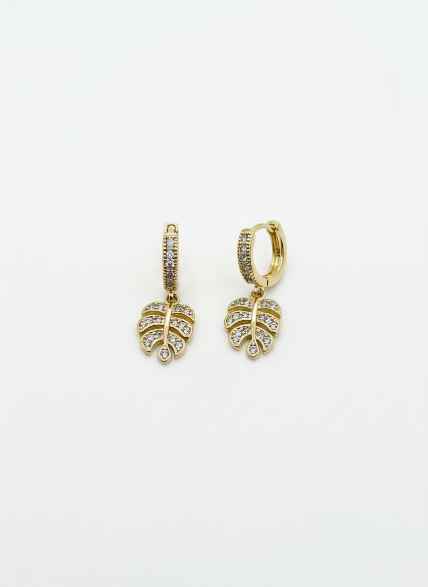 Stylish Monstera Shine Huggies by Gracie Rose Creative featuring sparkling crystal-studded leaves, perfect for adding a touch of tropical elegance to your look.