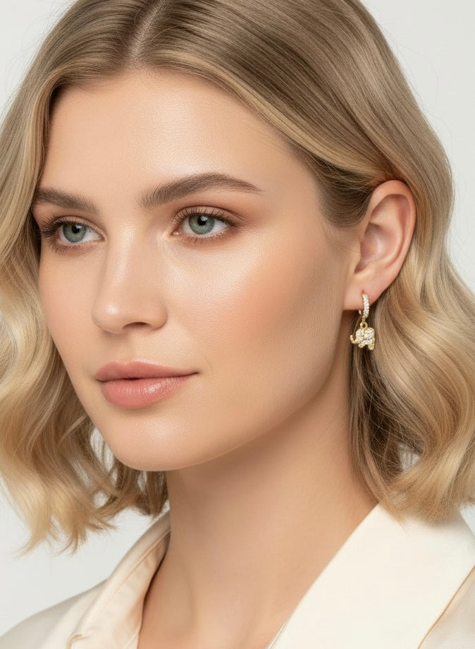 Lucky Elephant Drops by Gracie Rose Creative - Model wearing stunning gold elephant charm earrings, showcasing their elegance and shine.