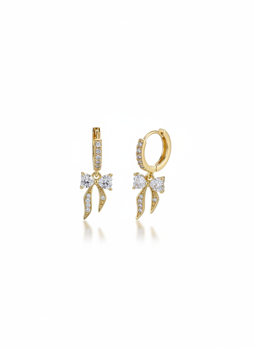 The Crystal Bows earrings by Gracie Rose Creative featuring radiant gold bows with sparkling crystal detailing, perfect for adding a touch of luxury and glamour.