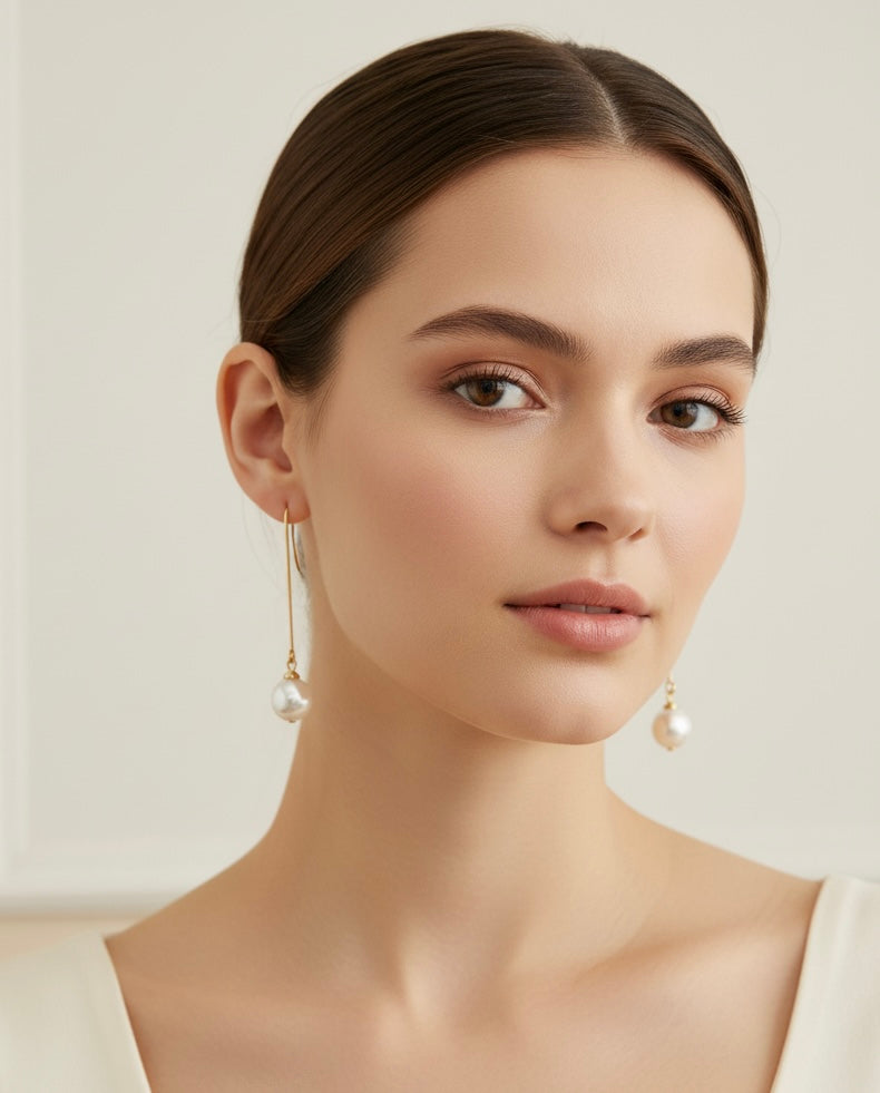 Model wearing Timeless Pearl Drops by Gracie Rose Creative, showcasing elegant handmade pearl earrings in a sophisticated setting.