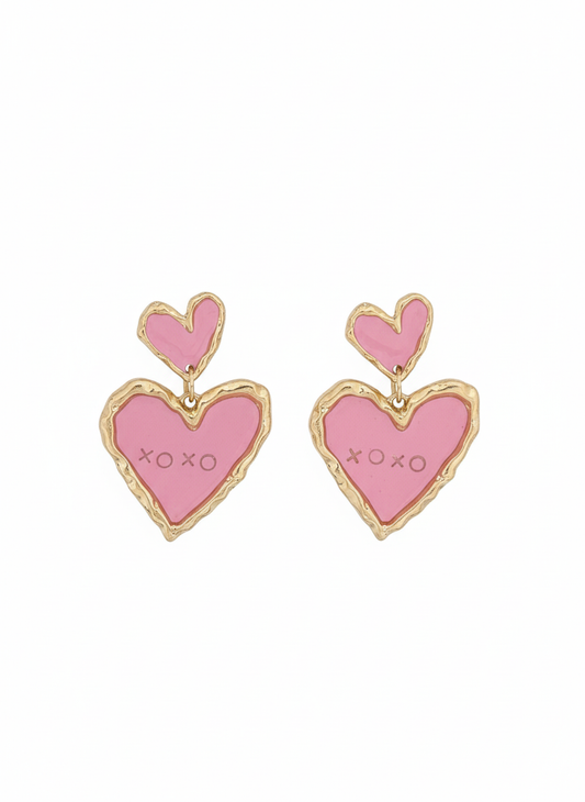Double Sweetheart in Pink statement earrings featuring a layered heart design in vibrant red and soft pink, elegantly framed in gold detailing.