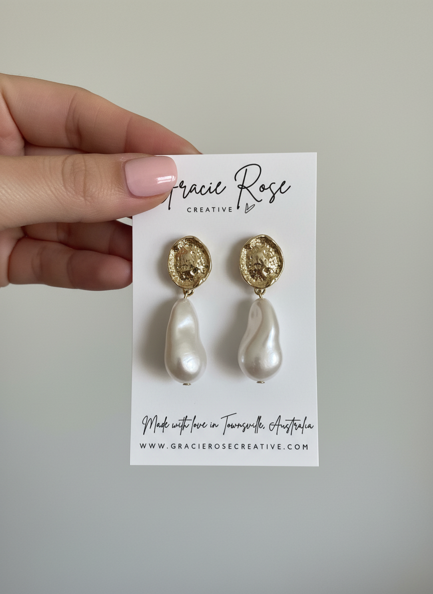 Amour Drop earrings displayed elegantly on a simple backdrop, highlighting their handmade charm and unique design.