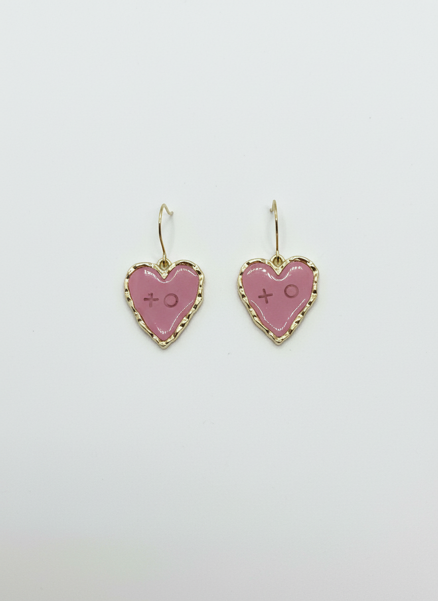 Mini XOXO earrings in pink, heart-shaped and handmade, featuring gold tones and stamped with xoxo.