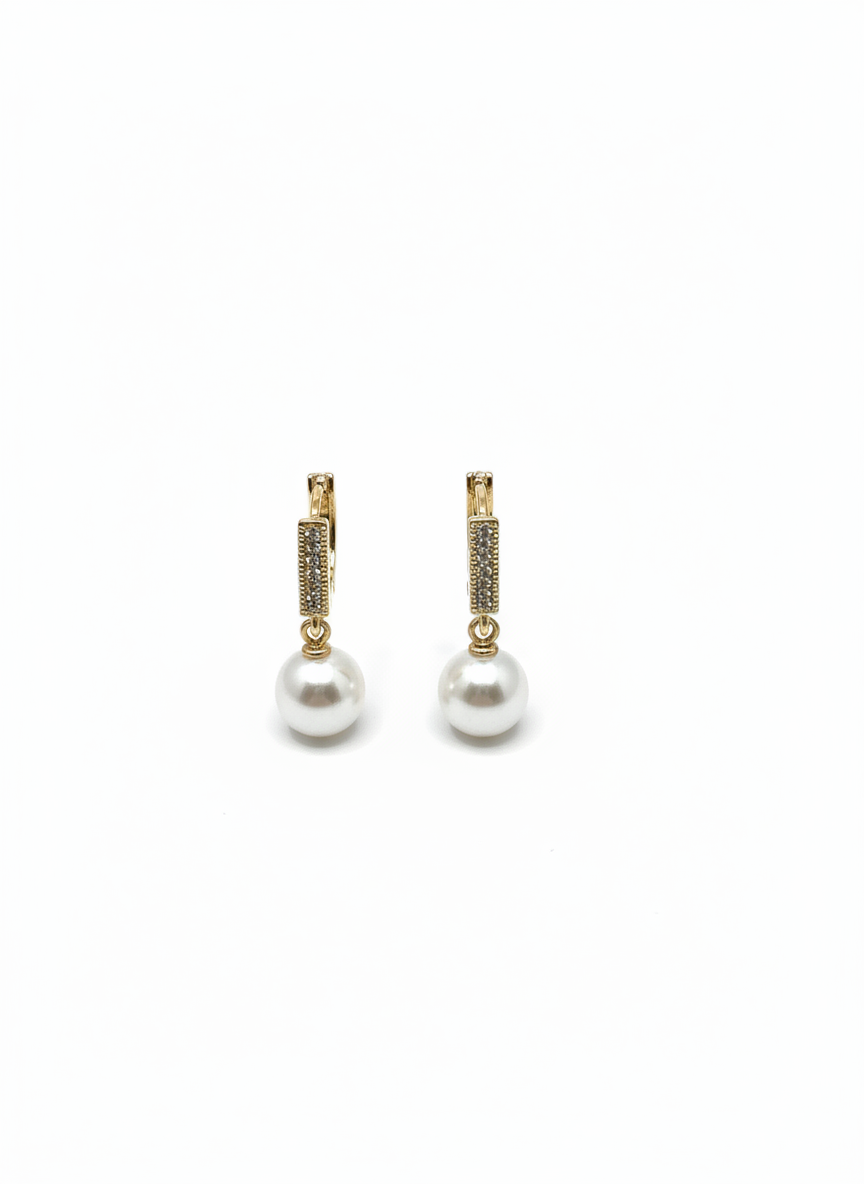 Pearl Swing Huggies by Gracie Rose Creative featuring playful pearl drops and 18ct gold plated huggie hooks, perfect for adding sparkle to any outfit.