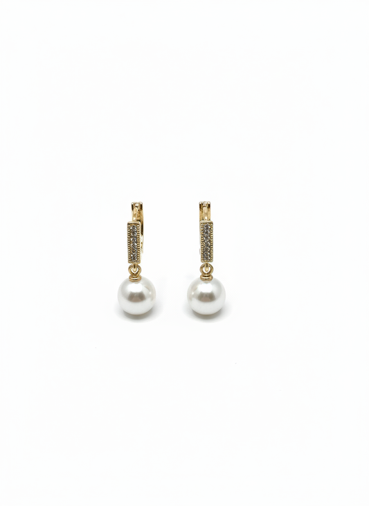Pearl Swing Huggies by Gracie Rose Creative featuring playful pearl drops and 18ct gold plated huggie hooks, perfect for adding sparkle to any outfit.