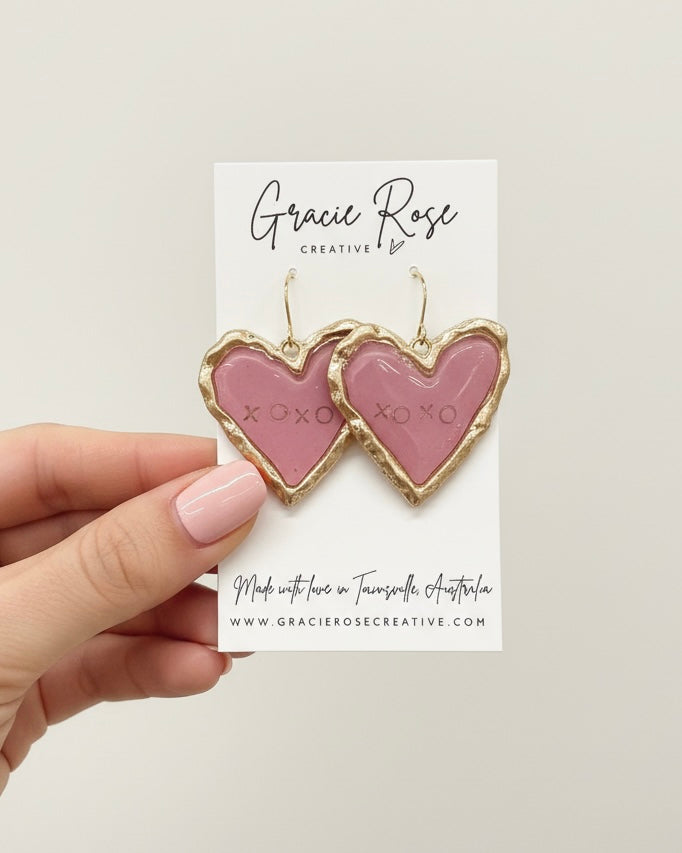 Stylish pink heart-shaped XOXO earrings, perfect accessory for any outfit, designed by Gracie Rose Creative.