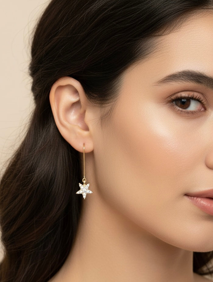 A model wearing Starlight Drops earrings by Gracie Rose Creative, showcasing the shimmering star dangles with a soft celestial glow.