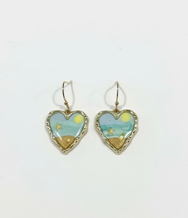 Handcrafted heart earrings titled 'Seaside Sweetheart' by Gracie Rose Creative featuring ocean blue and sandy tones with starfish details.