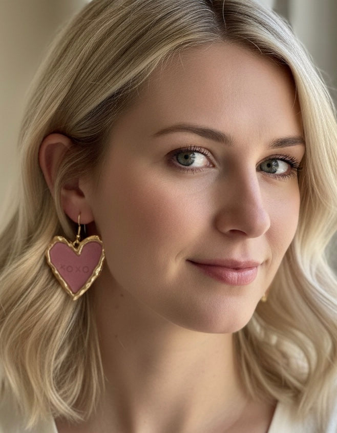 Close-up of pink XOXO earrings, beautifully crafted with polymer clay, showcasing unique handmade details.