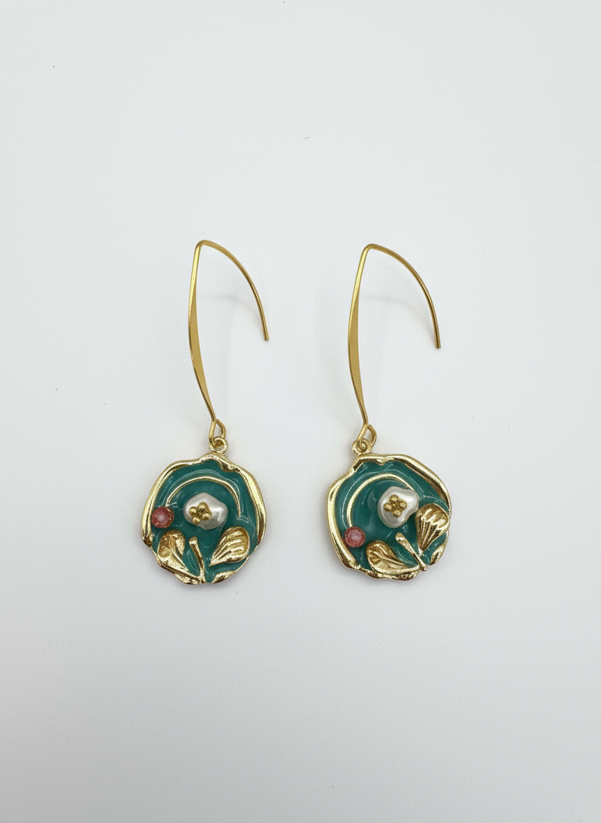 Heirloom Bloom baroque earrings by Gracie Rose Creative featuring rich teal tones, gold detailing, and pearl center, suspended from long gold hooks.