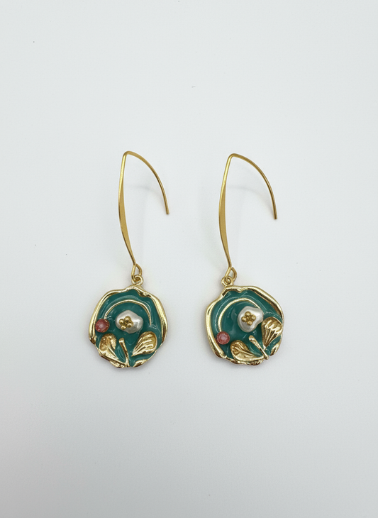 Heirloom Bloom baroque earrings by Gracie Rose Creative featuring rich teal tones, gold detailing, and pearl center, suspended from long gold hooks.