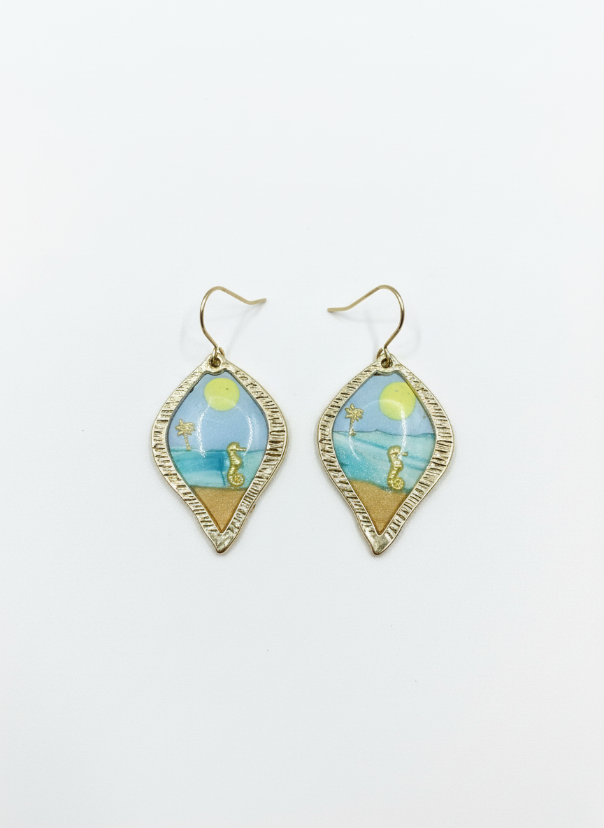 Stylish handmade drop earrings named Costal Daydream, featuring tranquil blue tones and sandy hues, showcasing delicate gold detailing.