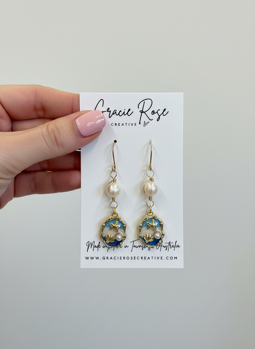 Handmade Siren Pearl drops earrings by Gracie Rose Creative, featuring pearls, gold details, and ocean-inspired blue design. Perfect for adding a coastal charm to any outfit.