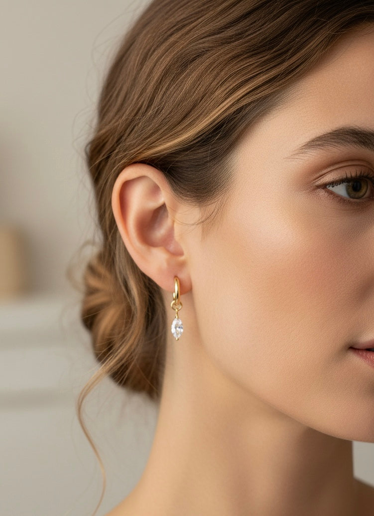Model wearing Crystal Kiss Huggies by Gracie Rose Creative, highlighting the elegant design of the gold plated earrings.