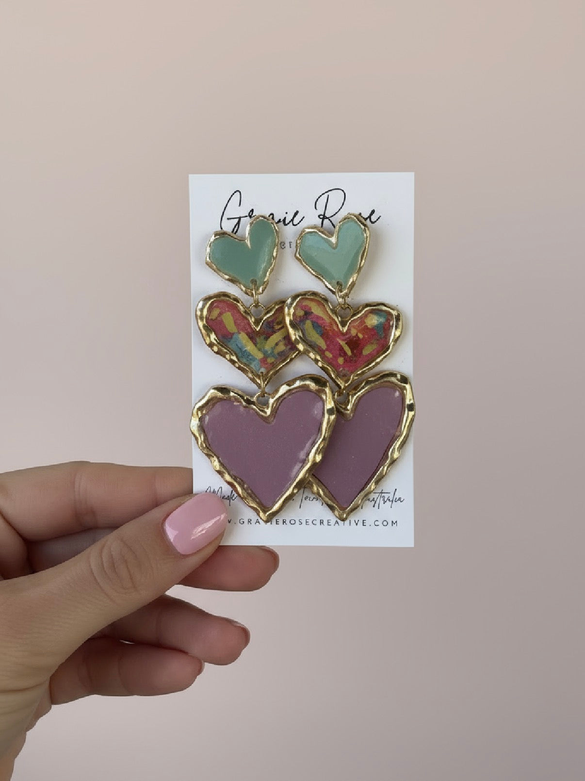 Stylish Cross Your Heart earrings displayed creatively, featuring delicate sculpted hearts perfect for modern romance.