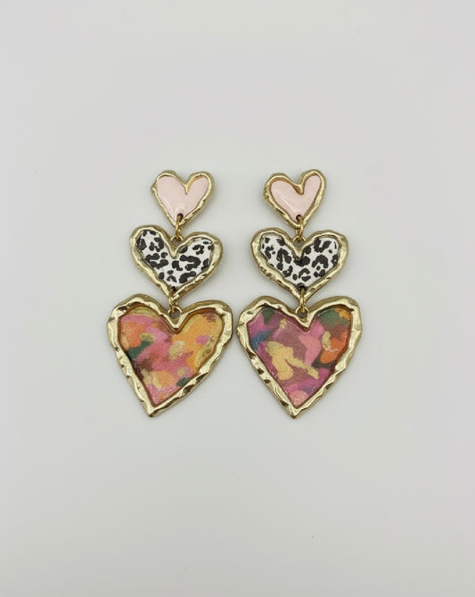 Cross Your Heart pink floral earrings by Gracie Rose Creative, featuring a trio of sculpted hearts in vibrant colors and patterns.