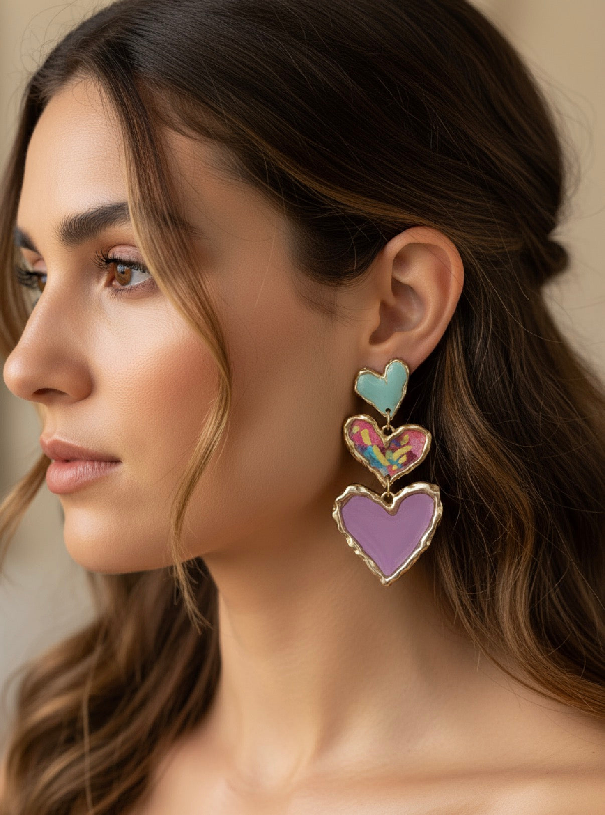 Close-up view of elegant Cross Your Heart earrings made of polymer clay in a beautiful floral sage color.
