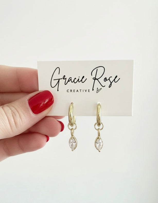 Crystal Kiss Huggies by Gracie Rose Creative displayed on a branded card, showcasing the stylish gold earrings.