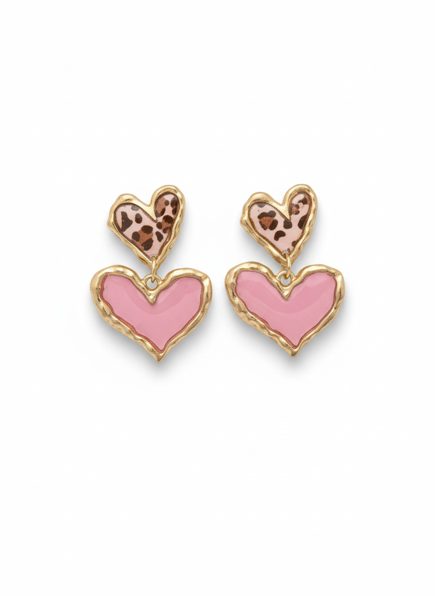 Stylish Cross Your Heart earrings in pink leopard print, featuring a double heart design with glossy bubblegum pink accents and a textured gold-tone frame, perfect for making a statement.